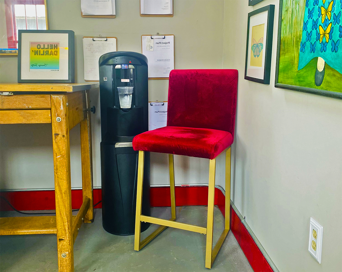 A water cooler next to a chair